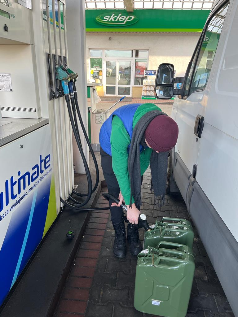 Volunteer refills diesel fuel canisters